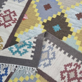 Collection of patterned rugs with geometric designs in various colors.