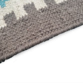 Close-up of a textured gray rug corner on a white background