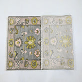Two floral-patterned rugs on a white background