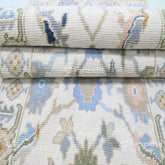 Close-up of a stack of patterned fabric rolls with floral designs.