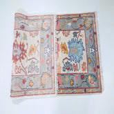 Two patterned rugs displayed side by side on a white background