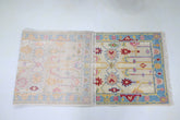 Soft ivory wool blend rug with colorful motifs
